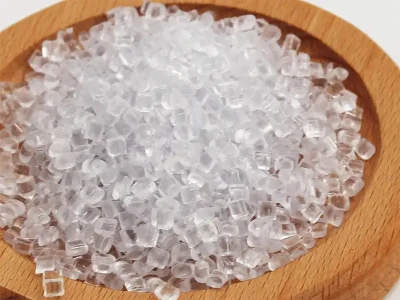 Cylindrical, oblate polystyrene (PS) pellets in transparent, milky-white, and light yellow colors.